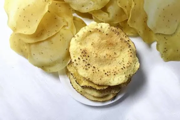 Jeera khichiya papad with cumin seeds, stacked on a plate