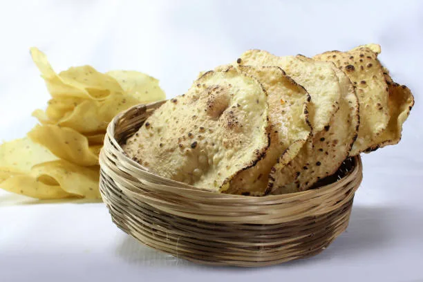 Khichiya papad stacked in a woven basket